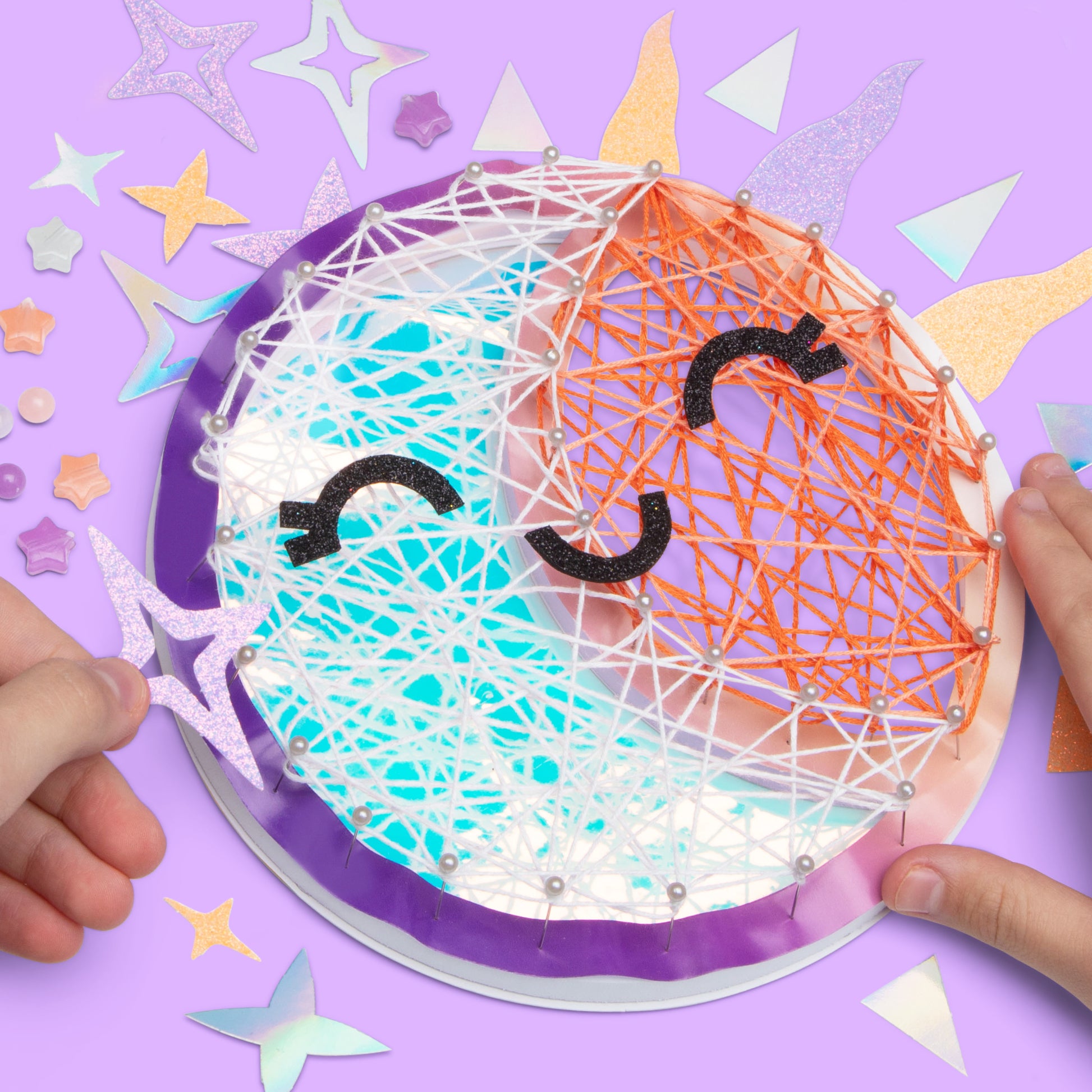Children's craft project with string art on a purple background
