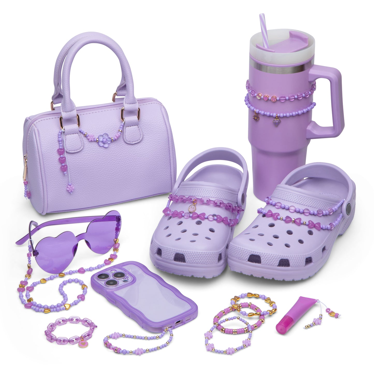 A purse, crocs, stanley, sunglasses, phone, bracelets, and lip gloss tube that have all been decorated with beads from the kit.