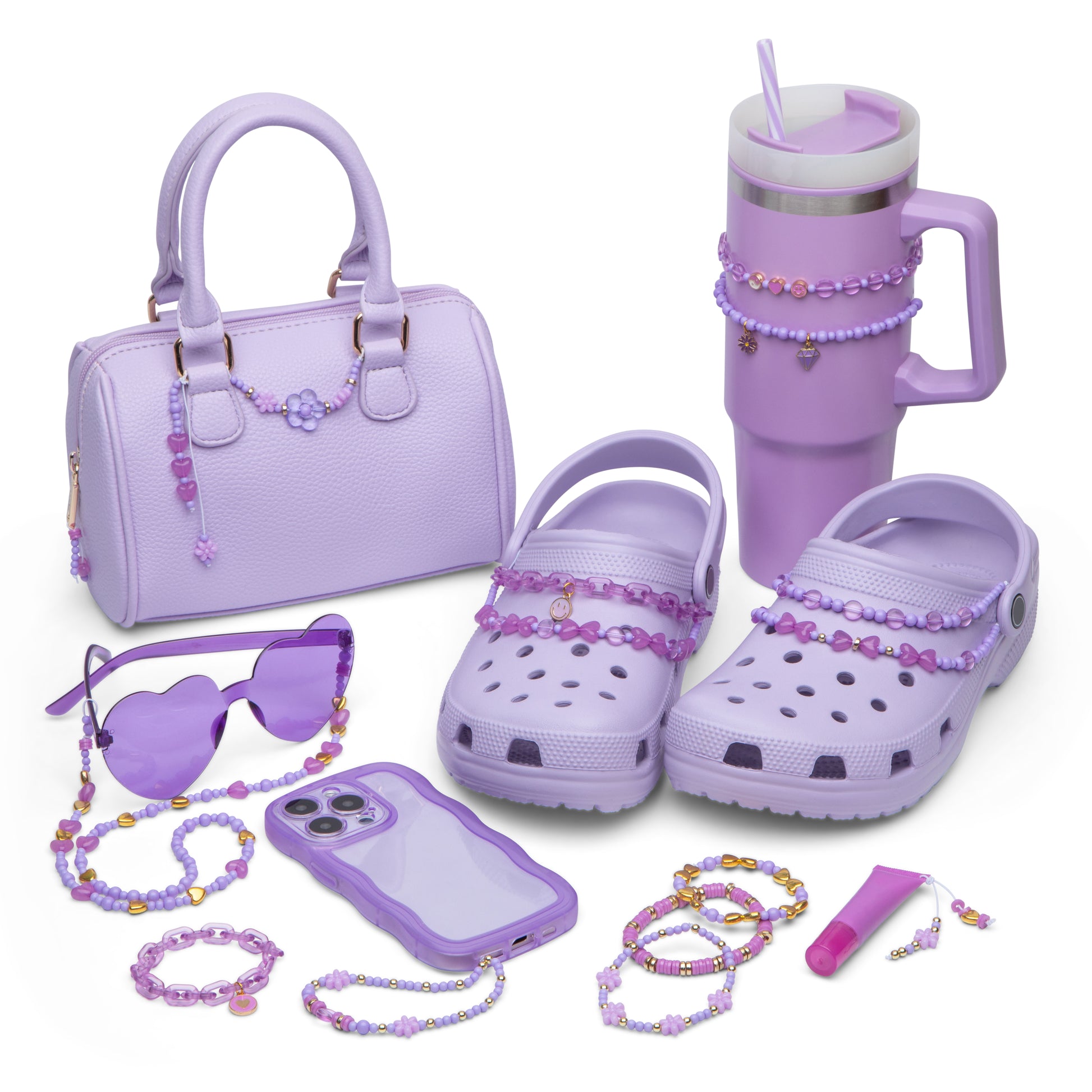 A purse, crocs, stanley, sunglasses, phone, bracelets, and lip gloss tube that have all been decorated with beads from the kit.