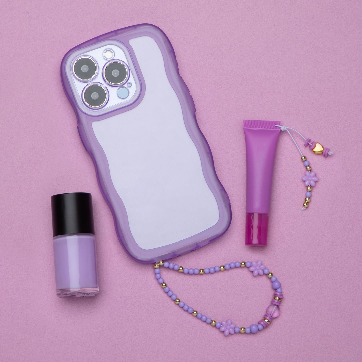 A phone case with a beaded handle and a lip gloss with a beaded tassel.