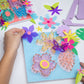 Child's hand holding a purple flower over the flower string art as they decide where to place.